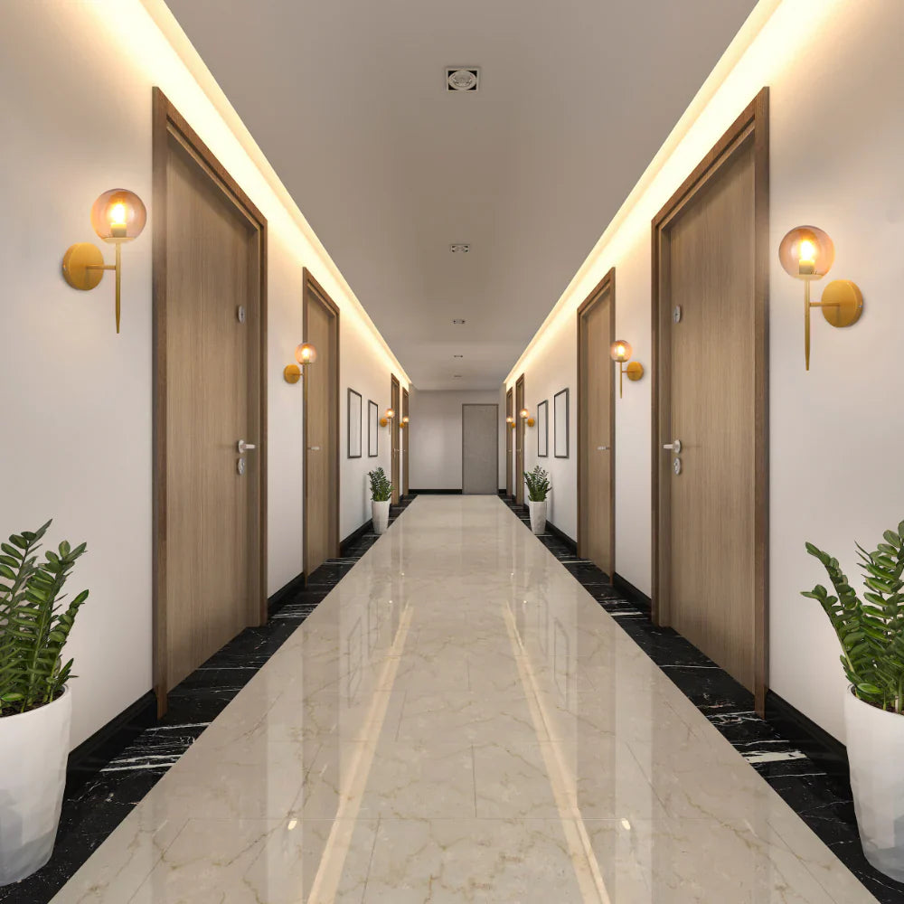 Mid-century Nordic Globe Sconce Modern Wall Light Gold Amber in hotel hallway