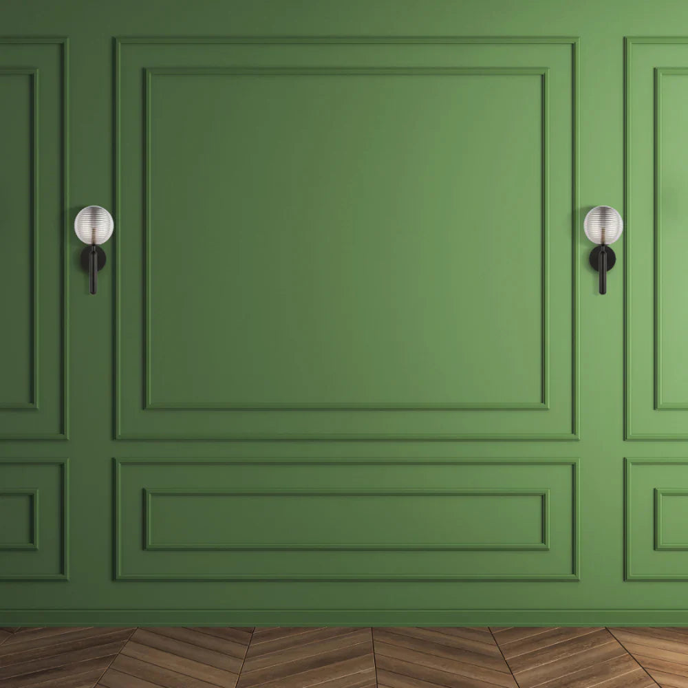Black Striped Reeded Glass Wall Light in action on a green wall