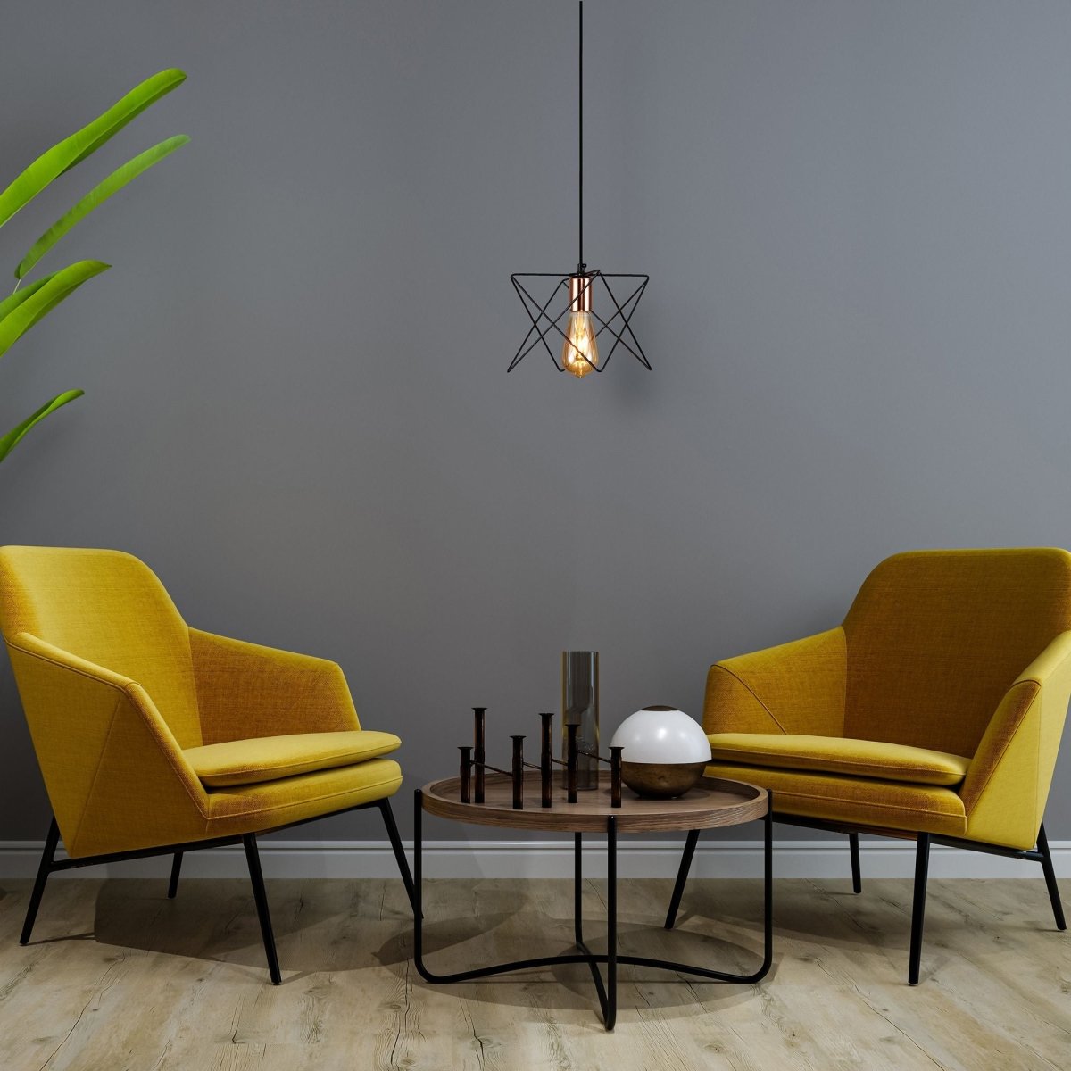 Black metal caged pendant light with e27 fitting in indoor setting reading room waiting room living room