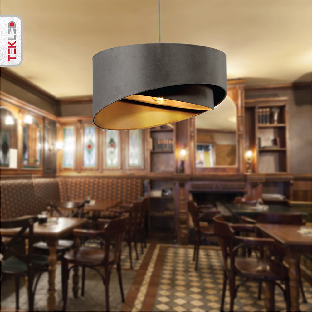 Grey fabric cylinder pendant light with e27 fitting in indoor setting cafe